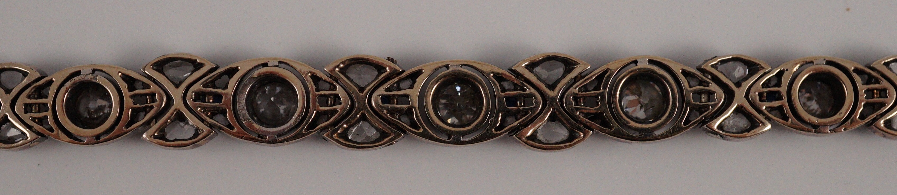 An early to mid 20th century continental gold and silver, graduated diamond and sapphire set line bracelet